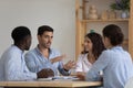 Serious engaged mentor man teaching diverse interns Royalty Free Stock Photo