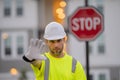 Serious engineer with stop road sign. Builder with stop gesture, no hand, dangerous on building concept. Man in helmet Royalty Free Stock Photo
