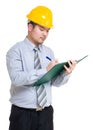 Serious engineer taking note on clipboard Royalty Free Stock Photo