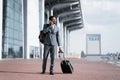 Serious Entrepreneur Talking On Cellphone Standing Near Airport, Full-Length Royalty Free Stock Photo