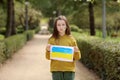 Serious face of a little girl. The child's cheeks are painted with the yellow and blue colors of the Ukrainian flag Royalty Free Stock Photo