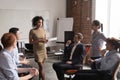 Serious female african coach mentor speaking at diverse team meeting Royalty Free Stock Photo