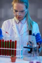 Serious female chemical technician working at night in the lab Royalty Free Stock Photo