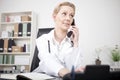 Serious Female Doctor Calling Through Telephone Royalty Free Stock Photo