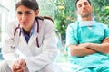 Serious female doctor with colleague in hospital Royalty Free Stock Photo