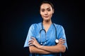 Serious female doctor looking camera and holding hands folded isolated Royalty Free Stock Photo