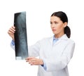 Serious female doctor looking at x-ray Royalty Free Stock Photo