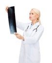 Serious female doctor looking at x-ray Royalty Free Stock Photo