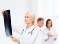 Serious female doctor looking at x-ray Royalty Free Stock Photo