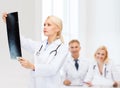 Serious female doctor looking at x-ray Royalty Free Stock Photo