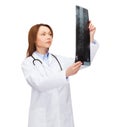 Serious female doctor looking at x-ray Royalty Free Stock Photo