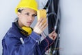 serious female electrician reading multimeter Royalty Free Stock Photo