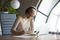 Female employee make notes watching webinar on laptop Royalty Free Stock Photo