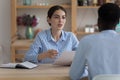 Serious female employer holding paper resume, interviewing job male candidate Royalty Free Stock Photo