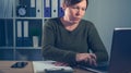 Serious female freelancer working on laptop computer Royalty Free Stock Photo