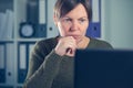 Serious female freelancer working on laptop computer Royalty Free Stock Photo