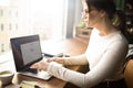 Pensive woman college student having online webinar via netbook gadget
