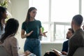 Serious female young business coach, team leader speaking before group Royalty Free Stock Photo