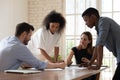 Serious focused diverse employees team working with documents together