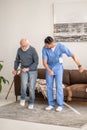 Concentrated elderly patient exercising with his physiotherapist