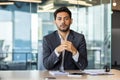 Serious and focused man at workplace looking at camera, webcam view, businessman listening to conversation using laptop Royalty Free Stock Photo