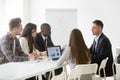 Serious focused multi-ethnic team listening to leader speaking a