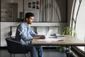 Serious focused young Indian project manager man typing on laptop Royalty Free Stock Photo