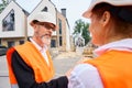 Construction personnel involved in discussion of building project documentation