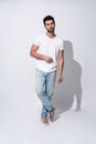 So serious. Full length of handsome young man in casual wear looking at camera while standing against grey background Royalty Free Stock Photo