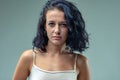 Serious girl, black hair, white tank top, determined or angry