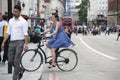 Serious girl in a blue dress with polka dots crossing the road o Royalty Free Stock Photo