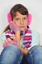 Serious girl with ear muffs and trimmed gloves Royalty Free Stock Photo