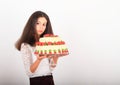 Serious girl holding anniversary cake