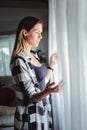 Serious girl looking trough window