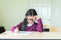 Serious girl writing on a blank paper in classroom Royalty Free Stock Photo