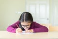 Serious girl writing on a paper in classroom Royalty Free Stock Photo