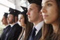 Serious graduates in mortars and gowns, head and shoulders