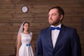 Serious groom in suit and happy bride Royalty Free Stock Photo