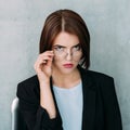 Serious grumpy business woman looking eyeglasses Royalty Free Stock Photo