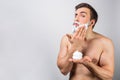 Serious guy is putting some shave cream ro shave his beard. This almost daily routine keeps him in tonus. Cut view Royalty Free Stock Photo