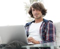 Serious guy working sitting near the desktop. Royalty Free Stock Photo