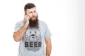 Serious handsome bearded man talking on cell phone Royalty Free Stock Photo