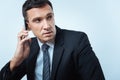 Serious handsome businessman having a phone conversation Royalty Free Stock Photo