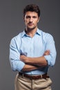 Serious handsome man with arms folded standing Royalty Free Stock Photo