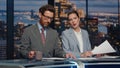 Serious hosts broadcasting news late studio closeup. Couple newscasters talking Royalty Free Stock Photo