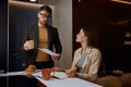 Serious husband holding paper asking wife about additional costs Royalty Free Stock Photo