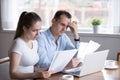 Worried husband and wife reading documents managing house paperw Royalty Free Stock Photo