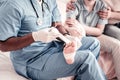 Close up of medical worker putting bandage on foot