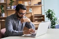 Serious indian businessman having video call with diverse people on laptop. Royalty Free Stock Photo