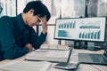 Serious Investors have a headache while working on the desk. Accounting and Financial concept